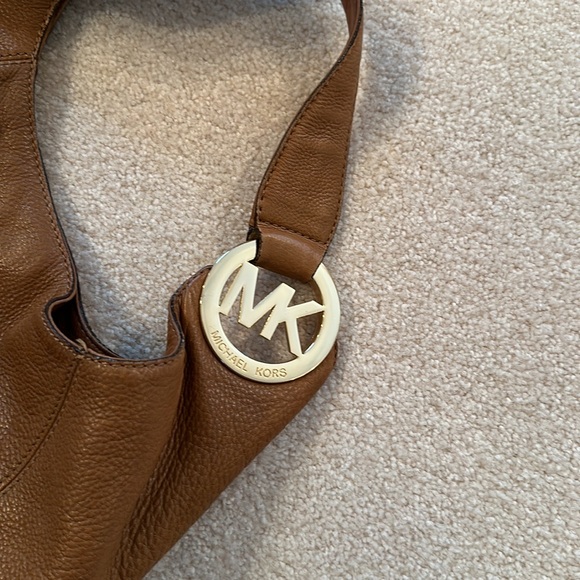 Michael Kors tan leather purse. Gold emblem. Gently used
Snap closure dust bag - Picture 2 of 9